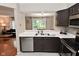 Kitchen view with stainless steel appliances and pass-through looking into adjacent dining room at 9154 Sea Oats Dr, Indianapolis, IN 46250