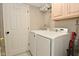 Bright laundry room with modern washer and dryer, storage shelves, and convenient access at 9154 Sea Oats Dr, Indianapolis, IN 46250