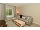 Cozy living room featuring a comfortable gray sofa, natural light from the window, and a modern coffee table at 9154 Sea Oats Dr, Indianapolis, IN 46250