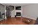 Cozy living room features a fireplace, mounted TV and hardwood flooring at 9154 Sea Oats Dr, Indianapolis, IN 46250