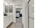 Bright bathroom featuring double sinks, elegant mirrors, and a view into the bedroom at 9363 Abner St, McCordsville, IN 46055