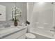 Bright bathroom featuring a combination tub and shower, granite vanity, and modern fixtures at 9363 Abner St, McCordsville, IN 46055
