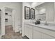Bright bathroom featuring double sinks, elegant mirrors, and a walk-in closet at 9363 Abner St, McCordsville, IN 46055