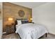 A beautifully decorated bedroom featuring a wood accent wall, lamps, and comfortable carpeting at 9363 Abner St, McCordsville, IN 46055
