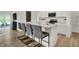 Modern kitchen featuring a large island with seating, stainless steel appliances, and white cabinets at 9363 Abner St, McCordsville, IN 46055