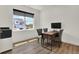 Bright office space featuring a wood desk, gray chairs, and a large window letting in natural light at 9363 Abner St, McCordsville, IN 46055