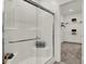Modern shower featuring a glass door, built-in bench, and a view into the walk-in closet at 9363 Abner St, McCordsville, IN 46055