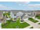 An aerial view of a charming two-story home with stone accents and a well-maintained lawn at 951 Parker Ln, Westfield, IN 46074