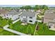 Aerial view of backyard showcasing lush lawn, privacy fence, and covered patio attached to a stylish home at 951 Parker Ln, Westfield, IN 46074