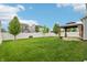 Landscaped backyard showcasing a well-manicured lawn, privacy fence, and charming pergola covered patio at 951 Parker Ln, Westfield, IN 46074