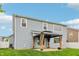 A well-maintained backyard features a blue home with grey trim and a covered patio at 951 Parker Ln, Westfield, IN 46074