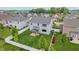 Aerial view of a spacious backyard featuring a covered patio, lush green lawn, and white picket fence at 951 Parker Ln, Westfield, IN 46074