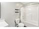Bathroom featuring a toilet, tiled tub with shower, and two shelves at 951 Parker Ln, Westfield, IN 46074