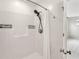 Bright tub and shower stall with shower curtain and mounted storage at 951 Parker Ln, Westfield, IN 46074
