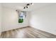 Bright bedroom featuring wood floors, a window with curtains and track lighting at 951 Parker Ln, Westfield, IN 46074