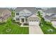 Beautiful two-story home boasts a stone facade, attached garage, pristine lawn, and mature trees at 951 Parker Ln, Westfield, IN 46074