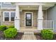 Inviting front porch with stone accents, white pillars, and manicured shrubs at 951 Parker Ln, Westfield, IN 46074