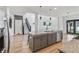 Bright, open kitchen featuring a large island, stainless steel appliances, and hardwood floors at 951 Parker Ln, Westfield, IN 46074