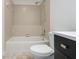 Bathroom with combined shower and tub, toilet, and dark wood vanity at 9572 Maple Way, Indianapolis, IN 46268