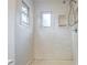 Updated bathroom featuring a walk-in shower, white marble, and natural light at 9572 Maple Way, Indianapolis, IN 46268
