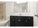 Bathroom vanity with dark wood cabinets, white countertop, and large mirror at 9572 Maple Way, Indianapolis, IN 46268