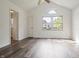 Bright bedroom with vaulted ceilings, hardwood floors, and sun-filled windows at 9572 Maple Way, Indianapolis, IN 46268