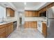 Functional kitchen with wooden cabinetry, stainless steel appliances, and ample counter space at 9572 Maple Way, Indianapolis, IN 46268