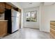 Bright kitchen with a window overlooking the outdoors and stainless steel refrigerator at 9572 Maple Way, Indianapolis, IN 46268