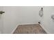 Empty laundry room with hookups, neutral walls, and laminate floors at 9572 Maple Way, Indianapolis, IN 46268