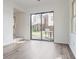 Open living room with a large sliding glass door leading to the outdoor patio at 9572 Maple Way, Indianapolis, IN 46268
