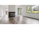 Bright and airy living room featuring a cozy fireplace and a beautiful view of the outdoors at 9572 Maple Way, Indianapolis, IN 46268