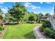 Manicured lawn with stone paver walkway and landscaped flowerbeds at 10036 E Troy Ave, Indianapolis, IN 46239
