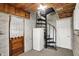 View of basement with spiral staircase, wood-paneled ceiling, and white brick walls at 10036 E Troy Ave, Indianapolis, IN 46239