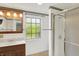 A cozy bathroom with white tile, a walk-in shower, and wood vanity at 10036 E Troy Ave, Indianapolis, IN 46239