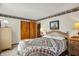 Charming bedroom featuring a wicker headboard, soft lighting, and a cozy quilt for a restful ambiance at 10036 E Troy Ave, Indianapolis, IN 46239