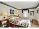 Charming bedroom featuring a wicker headboard, soft lighting, and a cozy quilt for a restful ambiance at 10036 E Troy Ave, Indianapolis, IN 46239