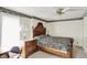 A relaxing bedroom featuring a decorative ceiling fan and a wooden bed frame at 10036 E Troy Ave, Indianapolis, IN 46239