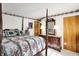 Bedroom with four-poster bed, floral patterns and elegant furnishings creating a cozy and inviting retreat at 10036 E Troy Ave, Indianapolis, IN 46239