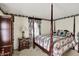 Bedroom with four-poster bed, floral patterns and elegant furnishings creating a cozy and inviting retreat at 10036 E Troy Ave, Indianapolis, IN 46239