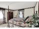 Bedroom with four-poster bed, floral patterns and elegant furnishings creating a cozy and inviting retreat at 10036 E Troy Ave, Indianapolis, IN 46239