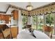 Bright dining area with large windows overlooking the backyard and wooden floors at 10036 E Troy Ave, Indianapolis, IN 46239