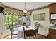Charming dining area with a chandelier, large windows, and hardwood floors at 10036 E Troy Ave, Indianapolis, IN 46239