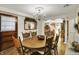 Open-concept dining room with a view of the kitchen and beautiful light fixtures at 10036 E Troy Ave, Indianapolis, IN 46239