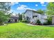 Two-story home showcasing lawn, stone foundation, and walk-out deck at 10036 E Troy Ave, Indianapolis, IN 46239