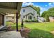 Home and backyard featuring large lawn, patio, and covered deck at 10036 E Troy Ave, Indianapolis, IN 46239