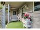 Inviting front porch area with a white bench, flowers, and overhead lighting at 10036 E Troy Ave, Indianapolis, IN 46239