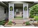 Covered front porch with lattice columns and flower planters at 10036 E Troy Ave, Indianapolis, IN 46239