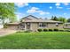 Charming two-story home featuring a stone facade and a lush green lawn at 10036 E Troy Ave, Indianapolis, IN 46239