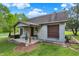 Exterior view of garage with covered porch and well-maintained yard at 10036 E Troy Ave, Indianapolis, IN 46239