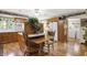 Large kitchen with hardwood floors, wooden cabinets, island with seating, and modern appliances at 10036 E Troy Ave, Indianapolis, IN 46239